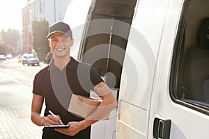 Courier Delivery Service. Man With Box Near Car Outdoors