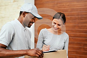 Courier Delivery Service. Man Delivering Package To Woman