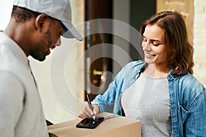 Courier Delivery Service. Man Delivering Package To Woman