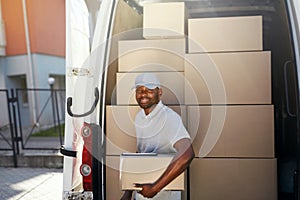 Courier Delivery Service. Man With Package Near Car With Boxes