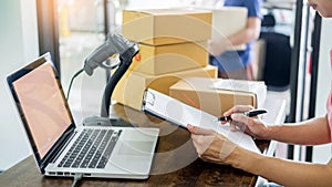 Courier hands Business woman work at home office checking parcel package box by keying machine track tools before ship and