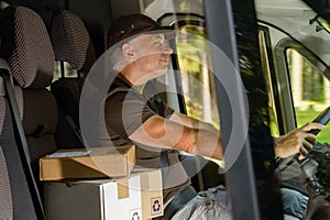 Courier man driving cargo car delivering package photo