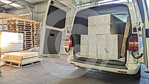 A courier picking up parcels from a delivery depot warehouse photo