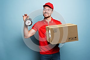 Courier is punctual to deliver the package. Emotional expression. Cyan background photo