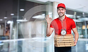 Courier is punctual to deliver quickly pizzas at home photo