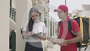 Courier in uniform delivering package to customers door