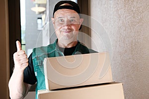 Courier, uniform mail worker brought a parcel to the address and gives it to customers, delivery of ordered goods, online shopping