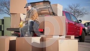 Courier Unloading Shipping Boxes Parcel From His Truck