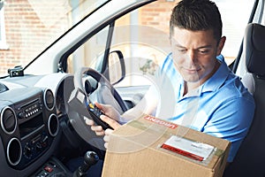 Courier In Van Delivering Package To Domestic House