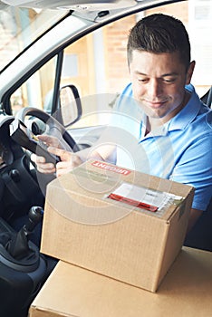 Courier In Van Delivering Package To Domestic House