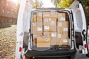 Courier van full of parcels and boxes photo