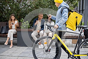 Courier walking with bicycle and business people