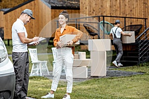 Couriers delivering goods to a woman home