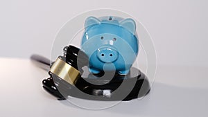 court gavel and piggy bank. Judge gavel and piggy banks, debt collection concept. stock footage. slow motion.