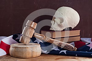 A court hammer and a skull on the background of the flag of the United States,