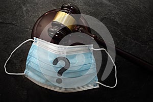 Court legal gavel and facemask with quetionmark -- Coronavirus mask mandate concept