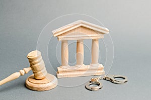 Courthouse and handcuffs. The concept of the court. Verdicts in criminal cases. Justice. The judicial system. Legal power.