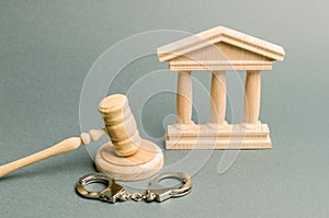 Courthouse and handcuffs. The concept of the court. Verdicts in criminal cases. Justice. The judicial system. Legal power.