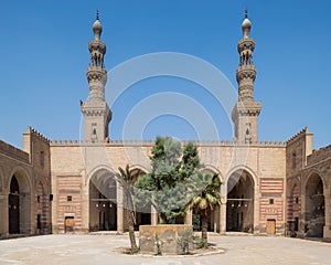 Courtyard of al Nasir Faraj ibn Barquq public historical mosque with two minarets, Cairo, Egypt