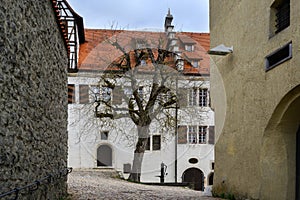 Courtyard with bare tree and fountain the castle Hellenstein on the hill of Heidenheim an der Brenz in southern Germany against a photo