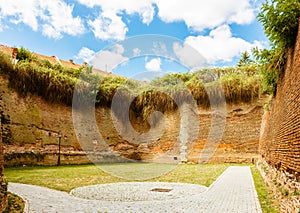 Courtyard of castle with tall brick walls