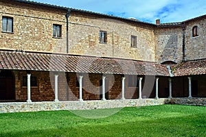 Courtyard with cloisters of a historic monastery in the city of Massa Maritima