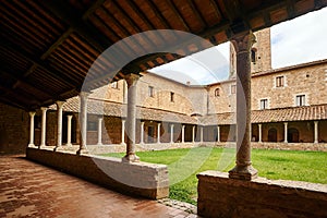 Courtyard with cloisters of a historic monastery in the city of Massa Maritima