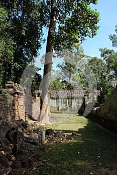 The courtyard of the dilapidated temple complex in Indochina. Ancient ruins in the forest