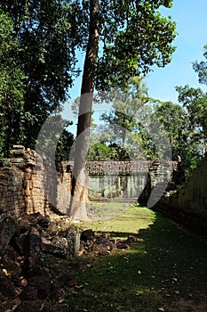 The courtyard of the dilapidated temple complex in Indochina. Ancient ruins in the forest