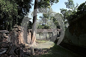 The courtyard of the dilapidated temple complex in Indochina. Ancient ruins in the forest