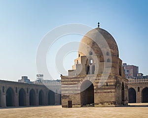 Courtyard of Ibn Tulun public historical mosque with ablution fountain and arched passages, Medieval Cairo, Egypt