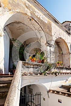A courtyard in the Italian village of Albori. Stairs to the balcony with arches