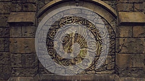 Courtyard of medieval castle, amazing large bas-relief with coat of arms, brown stone walls