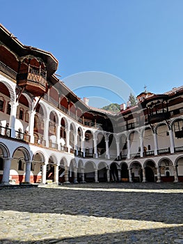 courtyard in monastery with wooden balconies and arches