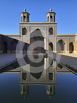 Courtyard of Nasir al Molk mosque. Pink Mosque is reflected in the pool.