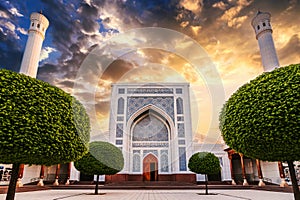 courtyard of the new white uzbek Islamic Masjid Minor Mosque in Tashkent in Uzbekistan on background of orange sunset