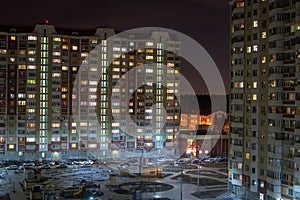 Courtyard of residential high-rise buildings in the night city