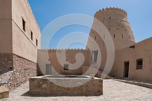 Courtyard of a small medieval arabian fort in Bukha, Oman. Windows, doors and round tower.