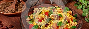 Couscous panorama with ingredients on a dark rustic wooden background