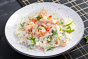 Couscous with roasted shrimps, tomatoes, red onions, almond nuts and parsley.