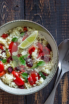 Couscous salad with tomatoes, peppers, courgettes and cranberries. Vegetarian food. Diet. Healthy eating