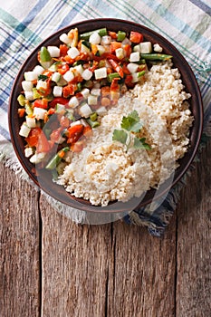 Couscous with vegetables and herbs. vertical top view