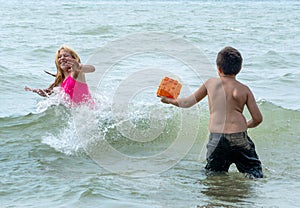 Cousins chase each other in the water