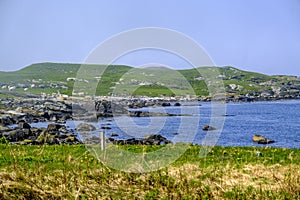 Cove Or Bay Surrounded By Green Hills Under A Misty Blue Sky