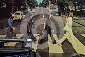 Cover of the famous Beatles Abbey Road album with a turntable in the foreground.