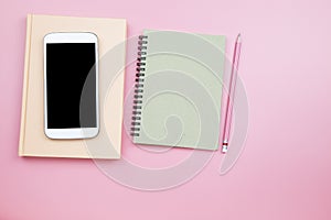 Cover notebook mobile phone pencil on pink background pastel sty