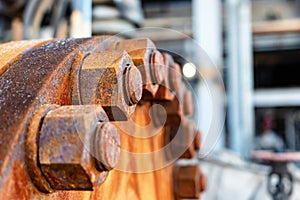 The cover of the old rusty heat exchanger covered with the same rusty bolts and nuts