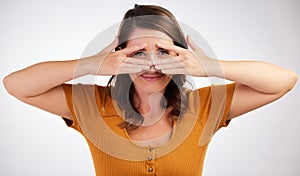 Cover, surprise and woman with hands on face to hide from scary fail in portrait on studio background. Girl, worry and