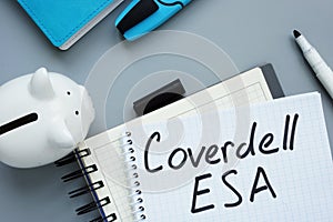 Coverdell ESA Education Saving Account. Notepad and piggy bank photo