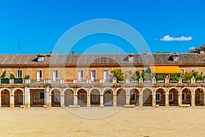 Covered arcade of royal palace at Aranjuez behind fence, Spain